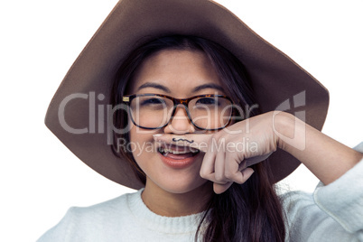 Asian woman with mustache on finger posing for the camera