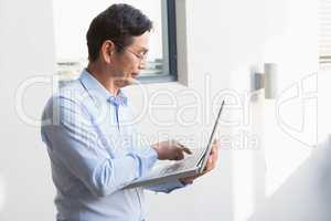 Concentrated man using laptop