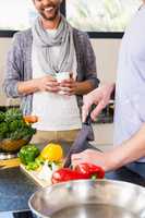 Mid section of gay couple preparing food