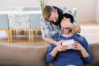 Gay man surprising his boyfriend