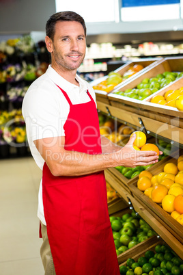 Portrait of male worker holding fruits