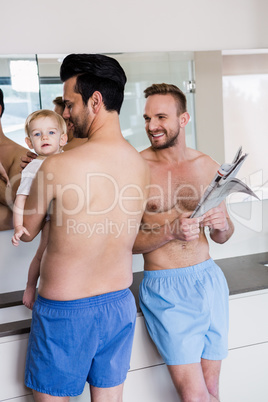 Smiling gay couple with child