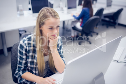 Serious student working on computer