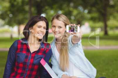 Smiling students taking a selfie outdoor