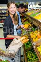 Cute couple choosing groceries together