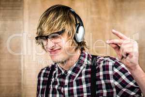 Cheerful blond hipster listening to music