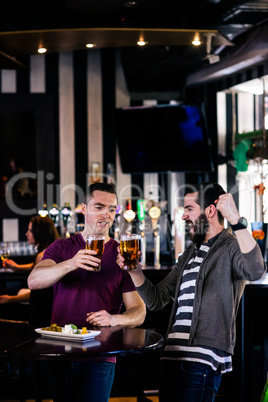 Friends having a pint and cheering