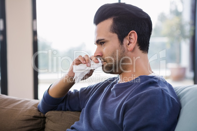 Handsome man sneezing