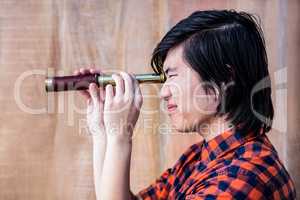 Hipster looking through a telescope