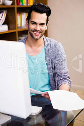 Smiling designer reading documents