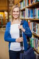 Smiling female student posing in the library