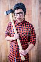 Serious hipster holding a axe