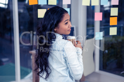 Asian woman holding disposable cup