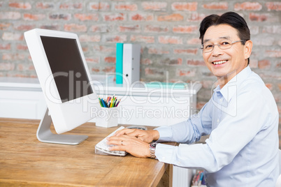 Smiling man using computer