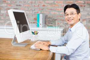 Smiling man using computer