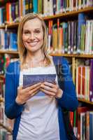 Female student using tablet in the library