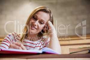 Female student taking notes in a class