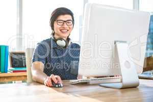 Smiling asian businessman using computer