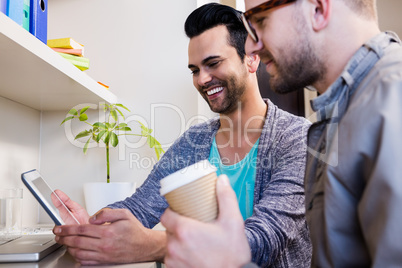 Happy gay couple using tablet