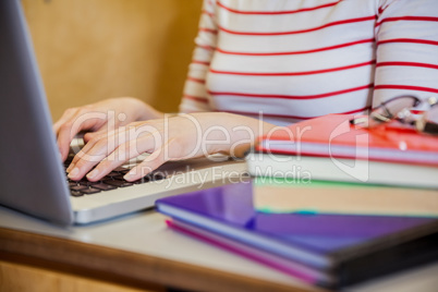 Female student typing on laptop