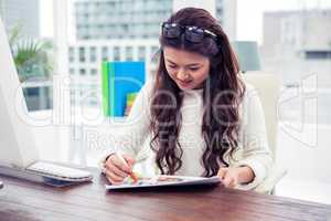 Smiling Asian woman looking at documents