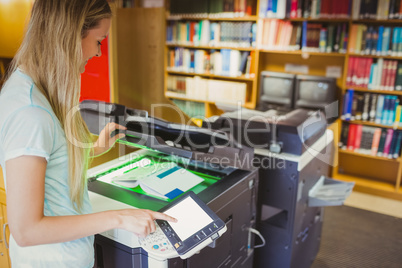 Smiling blonde student making a copy