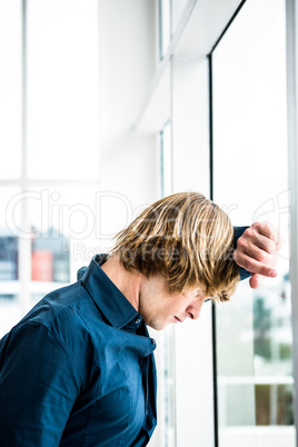 Hipster businessman looking out the window