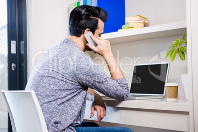 Busy man using smartphone and laptop