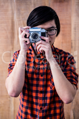 Hipster taking pictures with an old camera