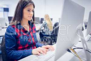 Serious student working on computer