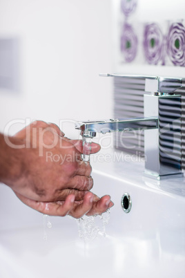 Close up of washing hands under running water