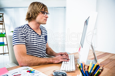 Concentrated hipster businessman using his computer