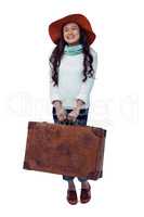 Smiling Asian woman holding luggage