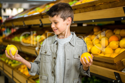 Little boy holding lemons