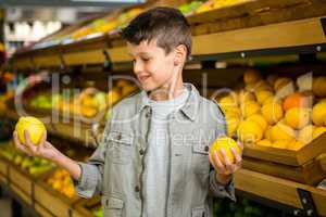 Little boy holding lemons