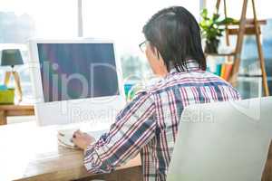 Rear view of businessman using computer