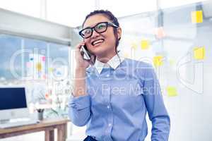 Smiling Asian businesswoman on phone call