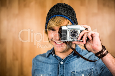 Smiling hipster man taking picture