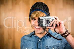 Smiling hipster man taking picture