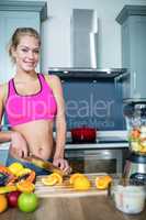 Fit woman cutting fruits