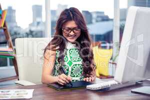 Smiling creative businesswoman using digital board