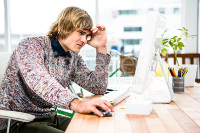 Troubled hipster businessman sitting in his office