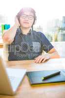 Smiling asian businessman listening to music