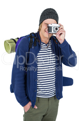 Backpacker hipster taking pictures with a retro camera