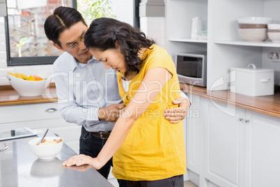 Husband taking care of his suffering pregnant wife