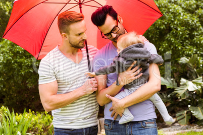 Smiling gay couple with child