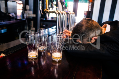 Drunk man with empty glasses