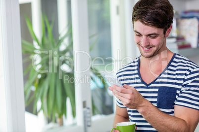 Smiling man staring at his smartphone