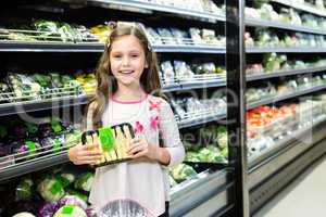 Cute girl holding asparagus