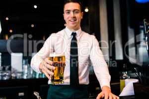 Barman serving a pint of beer
